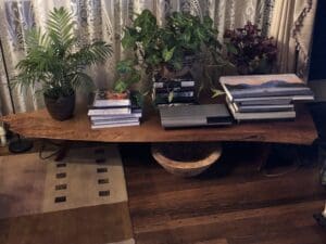 A George Nakashima conoid coffee table for sale rests indoors.